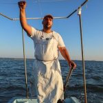 Fisherman Ahmed Chelli stands on his fishing boat around Tunisia’s