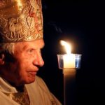 FILE PHOTO: Pope Benedict XVI prays while holding a candle