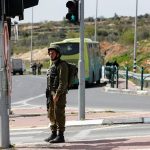 Israeli forces gather at the scene of stabbing attack at