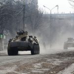 Armoured vehicles of pro-Russian troops drive along a street in