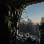 A Ukrainian serviceman looks on in Bakhmut