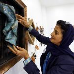 Awatif Al-Keneibit, a Saudi artist, shows her art in her