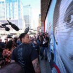 Brittney Griner unveils a mural painted by Antoinette Cauley, that