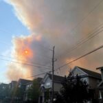 Smoke from the Tantallon wildfire rises over houses in nearby