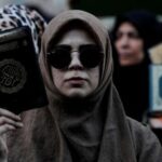 FILE PHOTO: Protesters hold copies of the Koran as they