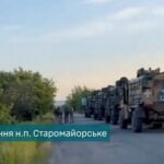 Military vehicles are seen as Ukrainian Armed Forces members liberate