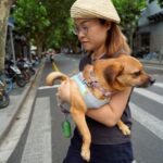 Pet owner Mi Jiayi holds her dog Mary in a