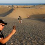 Tourists walk through the Maspalomas Dunes Special Natural Reserve in