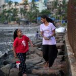 Maleesha Kharwa strolls with her cousin Liza Kharwa along a