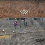 Workers build a heavily fortified underground school that will allow