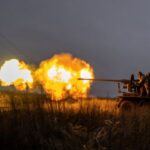 Ukrainian service members fire a S60 cannon towards Russian troops