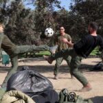 Israeli soldiers play near the Israel-Gaza border