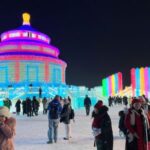 Visitors take pictures near ice sculptures at the Harbin Ice