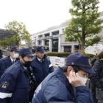 Police officers gather outside the Kyoto District Court ahead of
