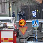 Emergency workers stand near the Israeli embassy in Stockholm