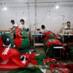 Workers prepare flags to be used for campaigns of political