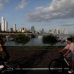 FILE PHOTO: People ride their bicycles, while the Panama City’s