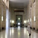 Woman walks along corridor at Milan Court of Justice
