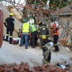 Rescuers work to rescue construction workers trapped under a building