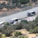 Trucks carrying aid to Gaza stand damaged at checkpoint near