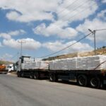 Trucks carrying aid to Gaza stand damaged at checkpoint near