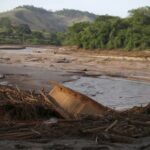A boat is pictured in Rio Doce after a dam,