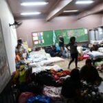 People evacuated from flooded areas, rest inside a classroom in