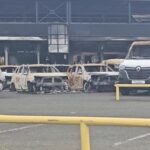 A view of burnt cars at a showroom in Noumea
