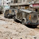 Israeli military vehicles are seen in Jenin