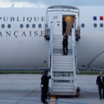 France’s President Emmanuel Macron waves as he boards his Presidential