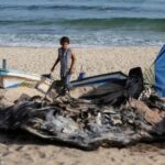 Palestinians inspect boats damaged in Israeli fire, in Rafah in