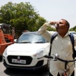 A man drinks a cooling drink offered by locals on
