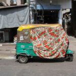 An autorickshaw covered with a cloth is seen on the