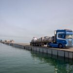 FILE PHOTO: Trucks deliver humanitarian aid over a temporary pier