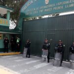 Police officers stand outside the police prison where ousted Peruvian