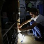 Ukrainian artist works in his apartment during blackout in Kyiv