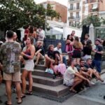 FILE PHOTO: Tourists and residents drink on a street in