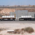 A truck carrying aid for delivery into Gaza drives through