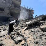 Palestinians search for casualties at the site of Israeli strikes