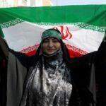 FILE PHOTO: An Iranian pro-government woman holds the Iranian flag