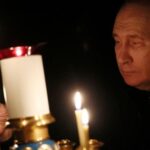 FILE PHOTO: Russian President Putin lights a candle in memory