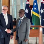 Solomon Islands Prime Minister Jeremiah Manele shakes hands with Australia