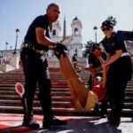Activists pour red paint on the Spanish Steps to protest