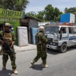 Kenyan police and Haitian National police SWAT units patrol streets