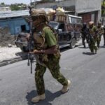 Kenyan police and Haitian National police SWAT units patrol streets