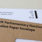 Photo illustration shows details of postal voting materials for Britain’s
