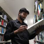 Prathesh Panjak, a first time immigrant voter, reads a book