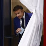 FILE PHOTO: French President Macron votes in the first round