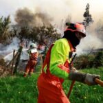 Firefighters tackle a blaze near the village of Setienes during