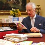 FILE PHOTO: Britain’s King Charles reads cards and message, in